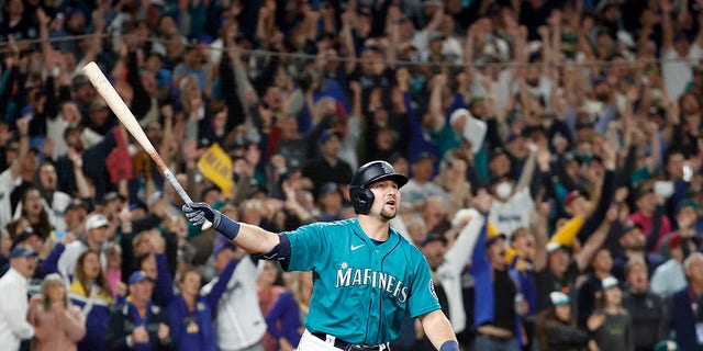 Cal Raleigh #29 of the Seattle Mariners celebrates his walk-off home run during the ninth inning against the Oakland Athletics at T-Mobile Park on September 30, 2022, in Seattle, Washington. With the win, the Seattle Mariners have clinched a postseason appearance for the first time in 21 years, the longest playoff drought in North American professional sports. 