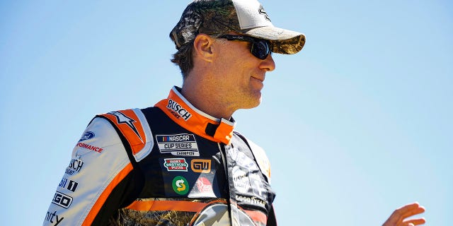 Kevin Harvick, driver of the #4 Busch Light Ford, waves to fans as he walks onstage during driver intros prior to the NASCAR Cup Series YellaWood 500 at Talladega Superspeedway on Oct. 2, 2022 in Talladega, Alabama.