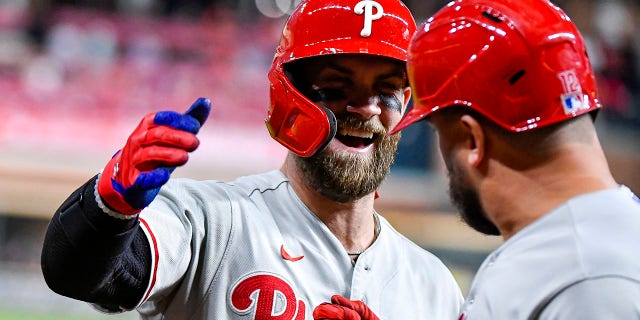 Bryce Harper #3 of the Philadelphia Phillies congratulates Kyle Schwarber, #12, after Schwarber hit a homerun in the first inning against the Houston Astros at Minute Maid Park on Oct. 3, 2022 in Houston.