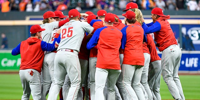 The Philadelphia Phillies celebrate after clinching the Wild Card, their first playoff berth since 2011 with a 3-0 win over the Houston Astros at Minute Maid Park on Oct. 3, 2022 in Houston. 