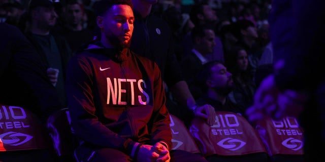 Ben Simmons of the Brooklyn Nets pauses on the bench during player introductions before a preseason game against the Philadelphia 76ers at Barclays Center Oct. 3, 2022, in the Brooklyn borough of New York City.