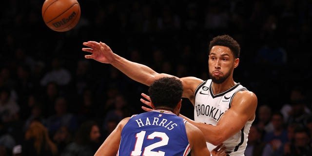 Ben Simmons (10) of the Brooklyn Nets passes the ball as Tobias Harris (12) of the Philadelphia 76ers defends in the first half during a preseason game at Barclays Center Oct. 3, 2022 in the Brooklyn borough of New York City.