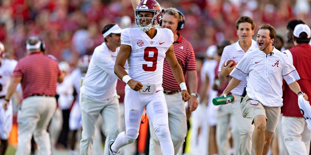 Bryce Young, #9 of the Alabama Crimson Tide, celebrates on the sidelines after his team scored a touchdown during a game against the Arkansas Razorbacks at Donald W. Reynolds Razorback Stadium on Oct. 1, 2022 in Fayetteville, Arkansas. The Crimson Tide defeated the Razorbacks 49-26.