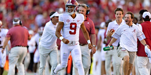 Bryce Young (9) of the Alabama Crimson Tide after his team scored a touchdown in a game against the Arkansas Razorbacks at Donald W. Reynolds Razorback Stadium in Fayetteville, Arkansas on Oct. 1, 2022. celebrates as a bystander. Razorbacks 49-26. 