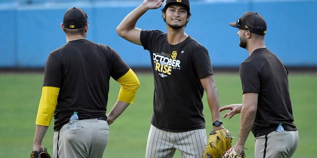 Yu Darvish of the San Diego Padres, center, talks to teammates before Game 1 of the NLDS against the Los Angeles Dodgers on Oct. 11, 2022, in Los Angeles.