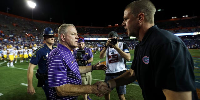 LSU Tigers head coach Brian Kelly, left, shakes hands with Florida Gators head coach Billy Napier, right, after a game at Ben Hill Griffin Stadium on Oct. 15, 2022 in Gainesville, Florida.