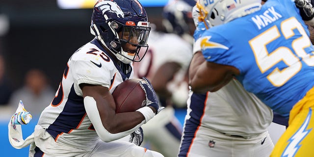Melvin Gordon III, #25 of the Denver Broncos, runs for yards during the first quarter against the Los Angeles Chargers at SoFi Stadium on Oct. 17, 2022 in Inglewood, California. 
