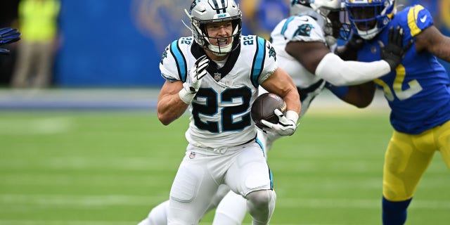 Christian McCaffrey, #22 of the Carolina Panthers, plays the ball while playing the Los Angeles Rams at Sophie Stadium on October 16, 2022 in Inglewood, California.