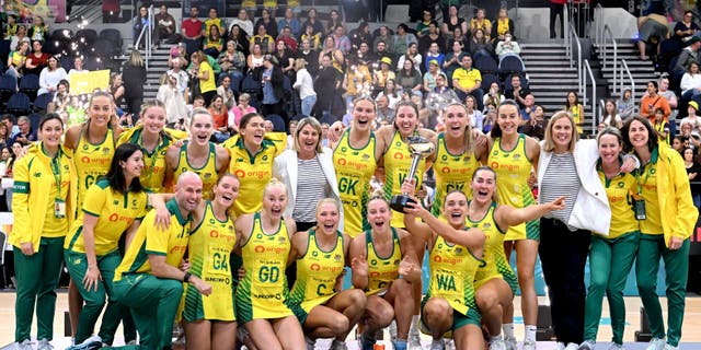 Liz Watson of Australia holds up the Constellation Cup as the Australian team celebrates victory after the Constellation Cup match between the Australia Diamonds and New Zealand Silver Ferns.