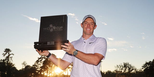 Rory McIlroy of Northern Ireland celebrates with the trophy after winning the final round of the CJ Cup at Congaree Golf Club on Oct. 23, 2022, in Ridgeland, South Carolina.