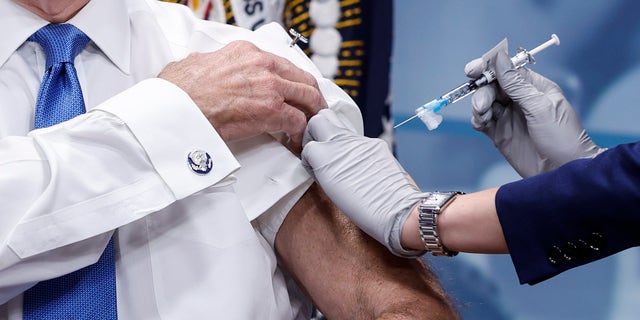 President Biden receives his updated COVID-19 booster in the South Court Auditorium at the White House campus on Oct. 25, 2022, in Washington.