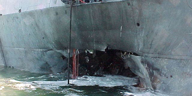 A gaping hole marred the port side of the Arleigh Burke-class guided missile destroyer USS Cole after a terrorist bomb exploded and killed 17 U.S. sailors and injured some 36 others during a refueling operation on October 12, 2000, in the port of Aden, Yemen.