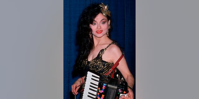 Tenuta's friends suggested that she incorporate an accordion into her act as she developed her whimsical, wisecracking persona, the "Love Goddess." 