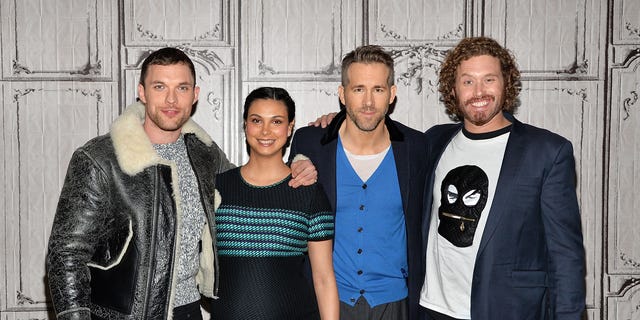 Ryan Reynolds is pictured alongside the cast of 'Deadpool,' Ed Skrein, Morena Baccarin, and T.J. Miller.