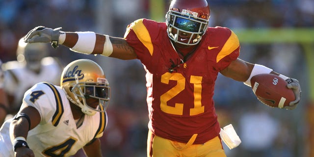 USC tailback LenDale White eludes the tackle of UCLA safety Jarred Page.