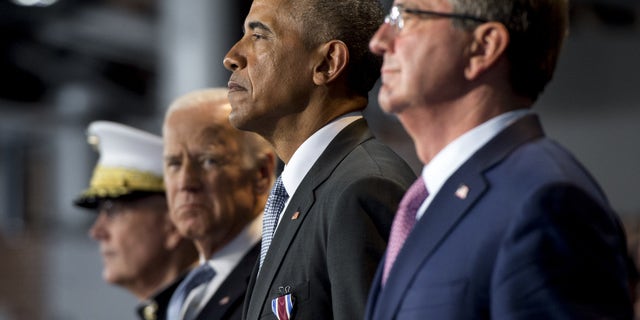 Former President Obama stands alongside Defense Secretary Ashton Carter and then-Vice President Joe Biden during the Armed Forces Full Honor Review Farewell Ceremony for Obama at Joint Base Myers-Henderson Hall.