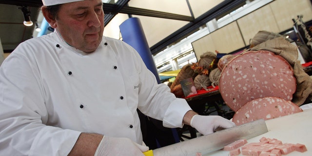 An exhibitor carves mortadella (pork sausage) at the Salone del Gusto, on Oct. 26, 2006, in Turin. 