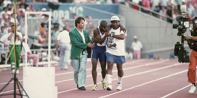 Great Britain's Derek Redmond, center, with his father after a hamstring injury during the men's 400M semifinal heat 1 at Estadi Olimpic de Montjuic at the Barcelona 1992 Summer Olympics.