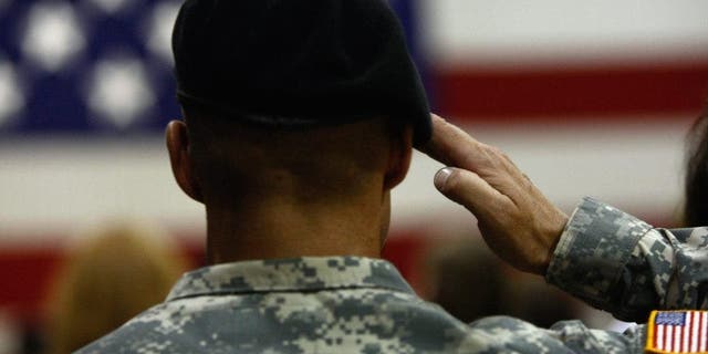 A U.S. Army soldier salutes during the national anthem as soldiers return home from Iraq on August 29, 2009, in Fort Carson, Colorado. The last main body, some 314 soldiers from the 2nd Brigade Combat Team of the 4th Infantry Division, returned home after a year deployment in Iraq. As American forces complete their deployments, the U.S. presence in Iraq continues to decrease as part of the draw down of American forces after more than 6 years war in Iraq. 