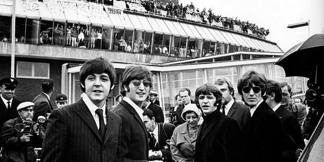 Photo of the Beatles — left to right, Paul McCartney, John Lennon, Ringo Starr and George Harrison — as they left Heathrow Airport for a final tour of the USA with cheering crowds seen everywhere.