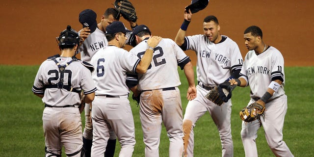 Joba Chamberlain is visited by Joe Torre in 2007 as he is surrounded by bugs on the mound.