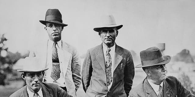 Four members of the six-man posse, who ambushed and killed fugitive criminals Clyde Barrow and Bonnie Parker near Gibsland, Louisiana, on May 23, 1934. They are pictured on the day following the ambush. Left to right, Dallas County Sheriff's Deputies Bob Alcorn and Ted Hinton and former Texas Rangers B.M. "Manny" Gault and Captain Frank Hamer.  