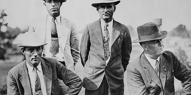 Four members of the six-man posse, who ambushed and killed fugitive criminals Clyde Barrow and Bonnie Parker near Gibsland, Louisiana, on May 23, 1934. They are pictured on the day following the ambush. Left to right, Dallas County Sheriff's Deputies Bob Alcorn and Ted Hinton and former Texas Rangers B.M. "Manny" Gault and Captain Frank Hamer.  