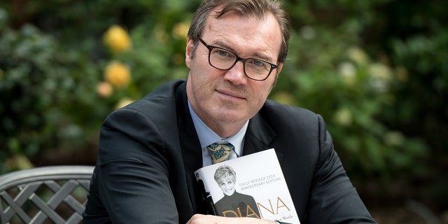 Andrew Morton poses with a copy of his book, ‘Diana: Her True Story — In Her Own Words’ at his home in London on August 24, 2017. Princess Diana rocked the monarchy when she leaked shocking details of palace life to the author.