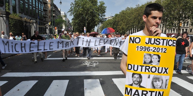 People protest on Aug. 19, 2012, against a court decision to grant parole to the ex-wife and accomplice of Belgian pedophile and serial killer Marc Dutroux. The demonstration was the latest in a series of protests following a court ruling to free Michelle Martin, who served 16 years of her 30-year sentence.