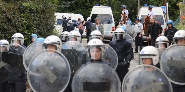 Belgian police act during a protest against the early release of Michelle Martin, ex-wife of child murderer Marc Dutroux, who stays at the Clarisse Monastery on Sept. 1, 2012, in Malonne, Belgium. 