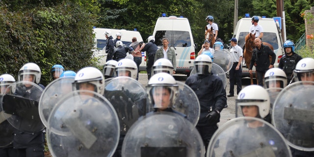 Belgian police act during a protest against the early release of Michelle Martin, ex-wife of child murderer Marc Dutroux, who stays at the Clarisse Monastery on Sept. 1, 2012, in Malonne, Belgium.