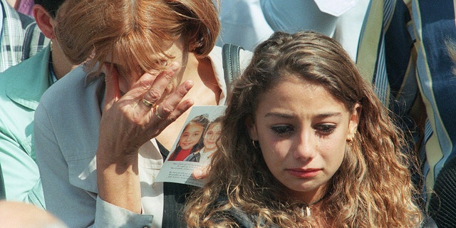 A mother and her daughter, friends of slain girls Melissa Russo and Julie Lejeune, are overcome by grief as they attend the funeral ceremony at Liege's Saint Martin Basilica on Aug. 22, 1996. The bodies of the two 8-year-old girls were discovered 14 months after their abduction. Marc Dutroux left them to starve to death.