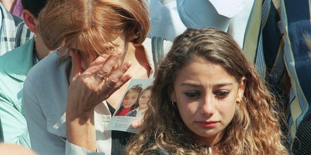 A mother and her daughter, friends of slain girls Melissa Russo and Julie Lejeune, are overcome by grief as they attend the funeral ceremony at Liege's Saint Martin Basilica on Aug. 22, 1996. The bodies of the two 8-year-old girls were discovered 14 months after their abduction. Marc Dutroux left them to starve to death.