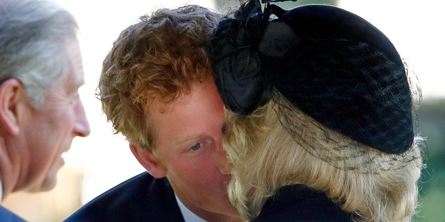 Prince Harry kisses Camilla, Duchess of Cornwall as they attend a Service of Thanksgiving for the life of Gerald Ward, godfather to Prince Harry, at St Mary's Church on Oct. 3, 2008, in Hungerford, England. Ward died on Sept. 23, 2008 at age 70.