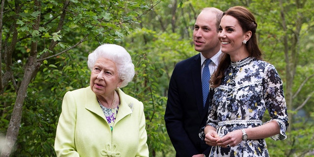 Kate Middleton, right, shows husband Prince William and Queen Elizabeth II around the "Back to Nature Garden" during their visit to the 2019 RHS Chelsea Flower Show in London on May 20, 2019.
