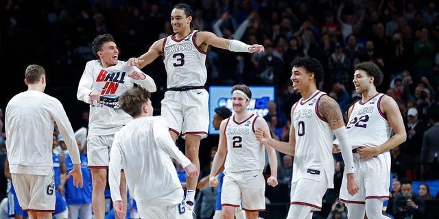 Gonzaga guard Andrew Nembhard, #3, and forward Drew Timme, #2, react with teammates after they beat Memphis 82-78 in a second-round NCAA college basketball tournament game, Saturday, March 19, 2022, in Portland, Oregon. 