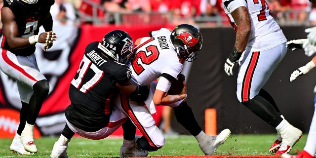 Grady Jarrett (97) of the Atlanta Falcons sacks Tom Brady (12) of the Tampa Bay Buccaneers during the fourth quarter of a game at Raymond James Stadium Oct.  9, 2022, in Tampa, Fla.