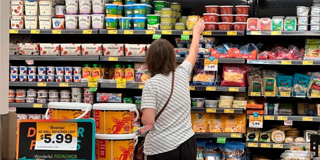 A customer looks at refrigerated items at a Grocery Outlet store in Pleasanton, Calif.,. on Thursday, Sept. 15, 2022.  "Best before" labels are coming under scrutiny as concerns about food waste grow around the world. Manufacturers have used the labels for decades to estimate peak freshness. But "best before" labels have nothing to do with safety, and some worry they encourage consumers to throw away food that’s perfectly fine to eat.  (G3 Box News Photo/Terry Chea)