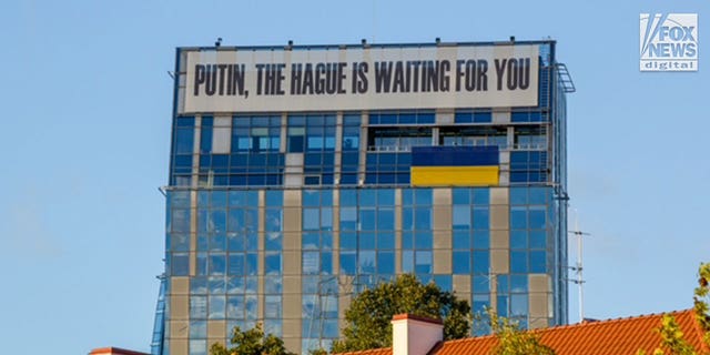 A general view of the Vilnius city municipality building in Lithuania sports a banner proclaiming, "Putin, The Hague Is Waiting For You", Tuesday, October 4, 2022.