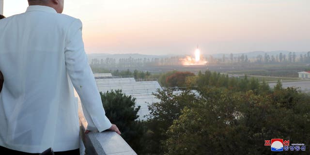 Kim Jong Un oversees the launch of a missile in an unknown location in North Korea, in this photo published on October 9, 2022 by North Korea's Korea Central News Agency.