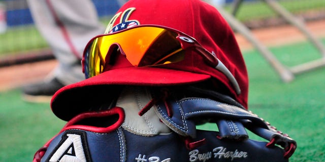 Outfielder Bryce Harper, #34 of the Harrisburg Senators, lets his hat and glove sit in the dugout during a game with the Akron Aeros on Aug. 18, 2011 at Canal Park in Akron, Ohio.