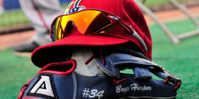 Outfielder Bryce Harper, #34 of the Harrisburg Senators, lets his hat and glove sit in the dugout during a game with the Akron Aeros on Aug. 18, 2011 at Canal Park in Akron, Ohio.