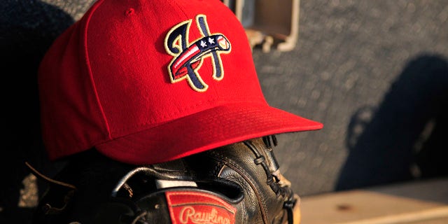 Harrisburg Senators baseball hat and baseball glove sit in the dugout before a game with the Akron Aeros on Aug. 18, 2011 at Canal Park in Akron, Ohio.