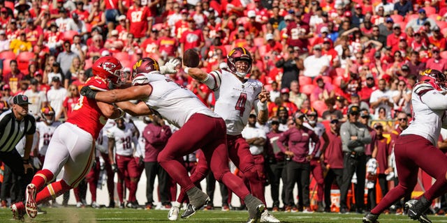 Taylor Heinicke (4) of the Washington Commanders throws a pass in the second quarter that led to the team's first touchdown in a game against the Kansas City Chiefs at Arrowhead Stadium Aug. 20, 2022, in Kansas City, Mo.