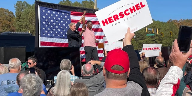 Herschel Walker is joined on the campaign trail by GOP Sen. Lindsey Graham of neighboring South Carolina, on Oct. 27, 2022, in Cumming, Georgia.