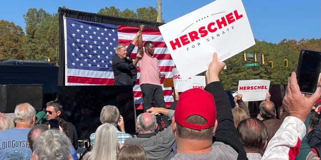 Herschel Walker is joined on the campaign trail by GOP Sen.  Lindsey Graham of neighboring South Carolina, on Oct. 27, 2022, in Cumming, Georgia.