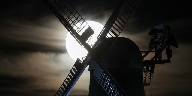 A near full Hunter's moon rises behind Wilton Windmill in Wiltshire, U.K.