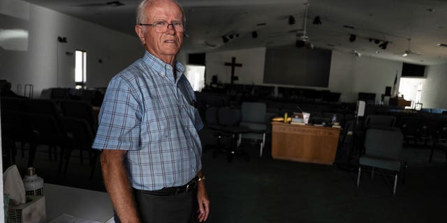 Pastor Robert Kasten, pastor of Southwest Baptist Church in Fort Myers, Florida, stands at the sanctuary where parishioners evacuated when Hurricane Ian hit southwest Florida on Sunday, October 2, 2022. .  (AP Photo/Robert Bumsted)