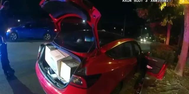 Body cam footage from the City of Atlanta Police Department of an alleged thief of Amazon packages from multiple homes driving a red Tesla sedan.