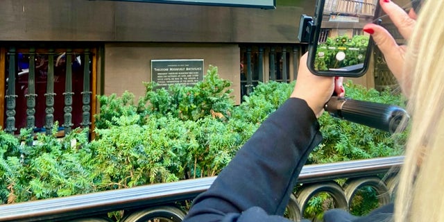 Travel writer Karen Loftus snaps a photo of the Theodore Roosevelt Birthplace National Historic Site in Manhattan, where the 26th president was born Oct. 27, 1858.